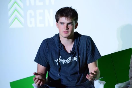 Brennan Agranoff speaking on stage in a HoopSwagg shirt